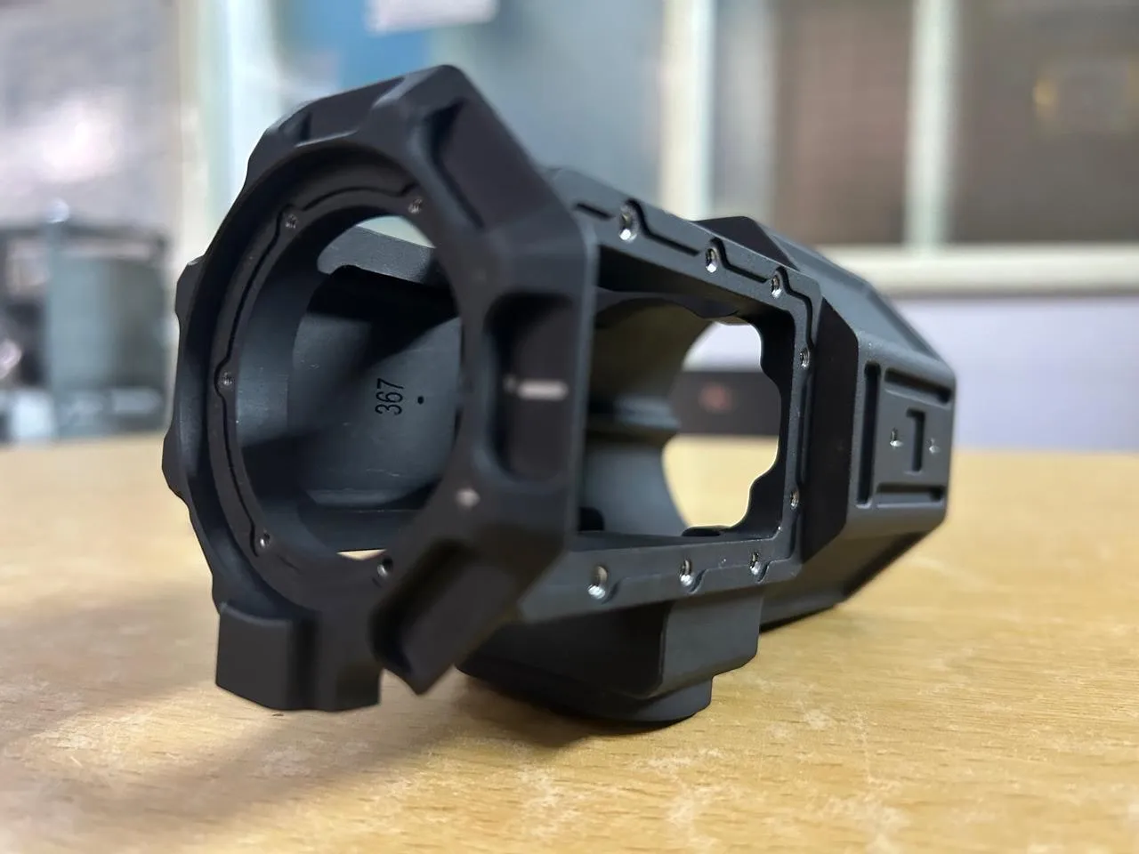 Black anodised machined aluminium housing with a precision-machined frame and bored front face