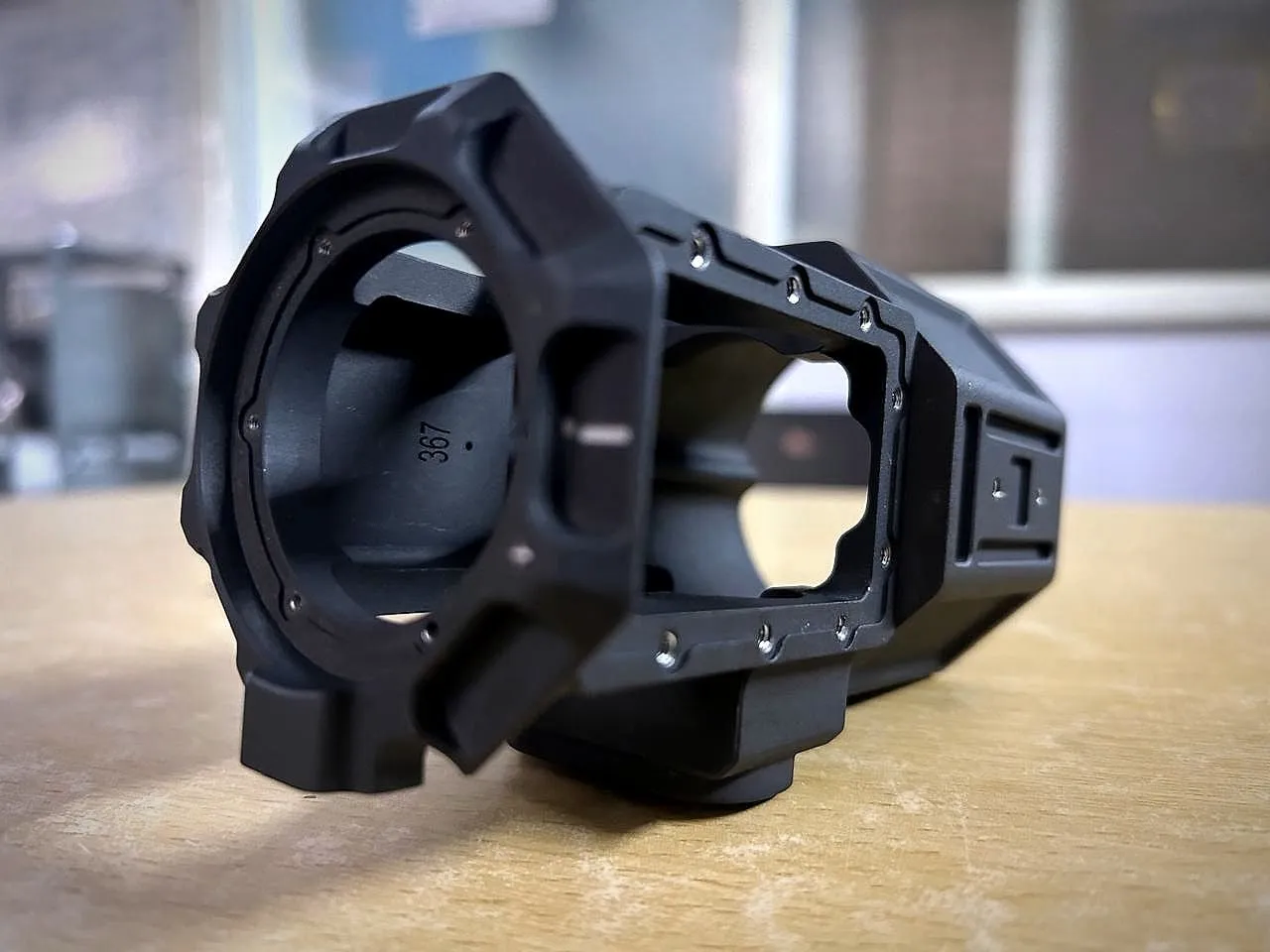 Black anodised machined housing with a bored front face